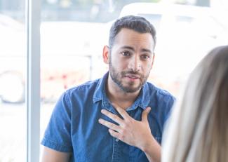 Man with his hand on his chest