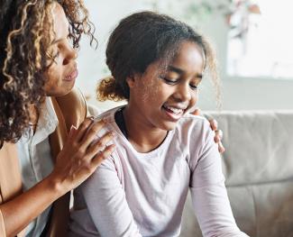 Girl being comforted by her mother